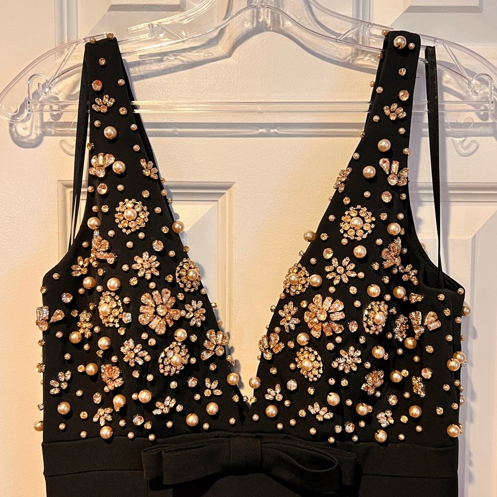 Embody elegance in this beaded crepe gown.